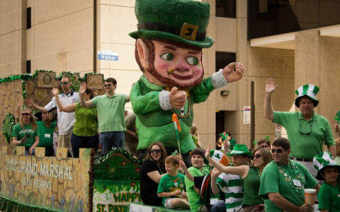 St Patricks Day Parade Float with waving people and giant leprechaun